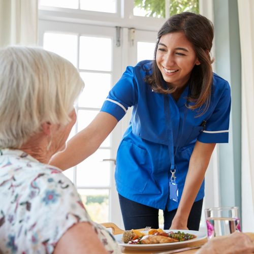 care-nurse-serving-dinner-to-a-senior-woman-at-hom-2021-08-26-16-13-54-utc (1)